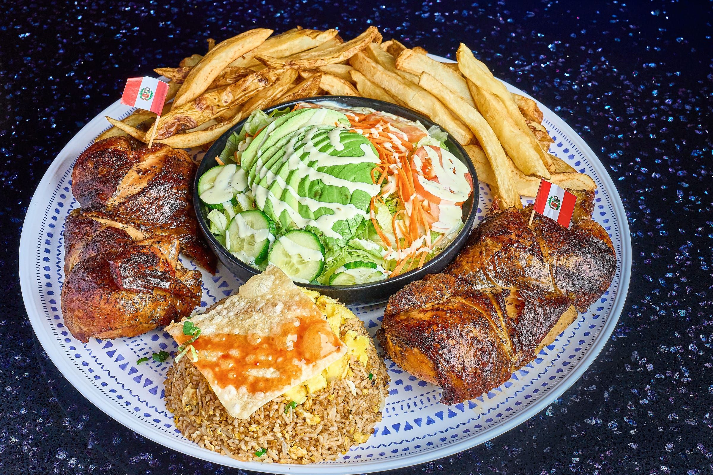 A whole charcoal-roasted chicken with chaufa, fries, and salad